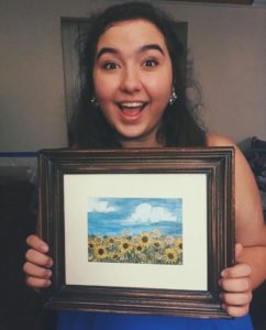 sydney holding sunflower painting 