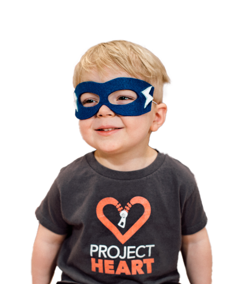 Small boy with superhero mask and project heart shirt on.